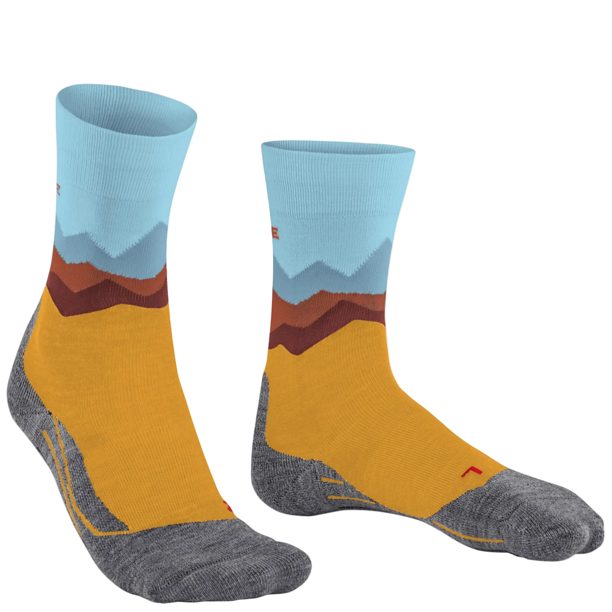 A pair of crew socks with a stylized mountain landscape print. The design features a light blue cuff, layered brown and gray mountains, a mustard yellow midsection, and a heather gray toe and heel.