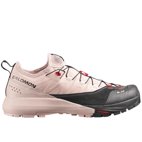 Salomon trail running shoe in light beige and black with red accents, shown from the side against a light gray background.