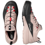 A pair of Salomon hiking shoes shown from the top and side views against a light gray background. The shoes feature a light beige upper with black overlays, black laces, and red accents.