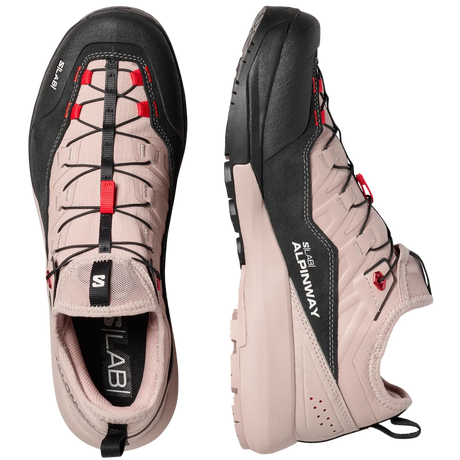 A pair of Salomon hiking shoes shown from the top and side views against a light gray background. The shoes feature a light beige upper with black overlays, black laces, and red accents.