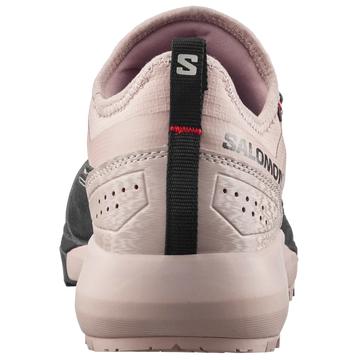 A close-up rear view of a Salomon shoe in light beige and pinkish-beige, featuring a black heel pull tab with the Salomon 'S' logo and 'SALOMON' branding.
