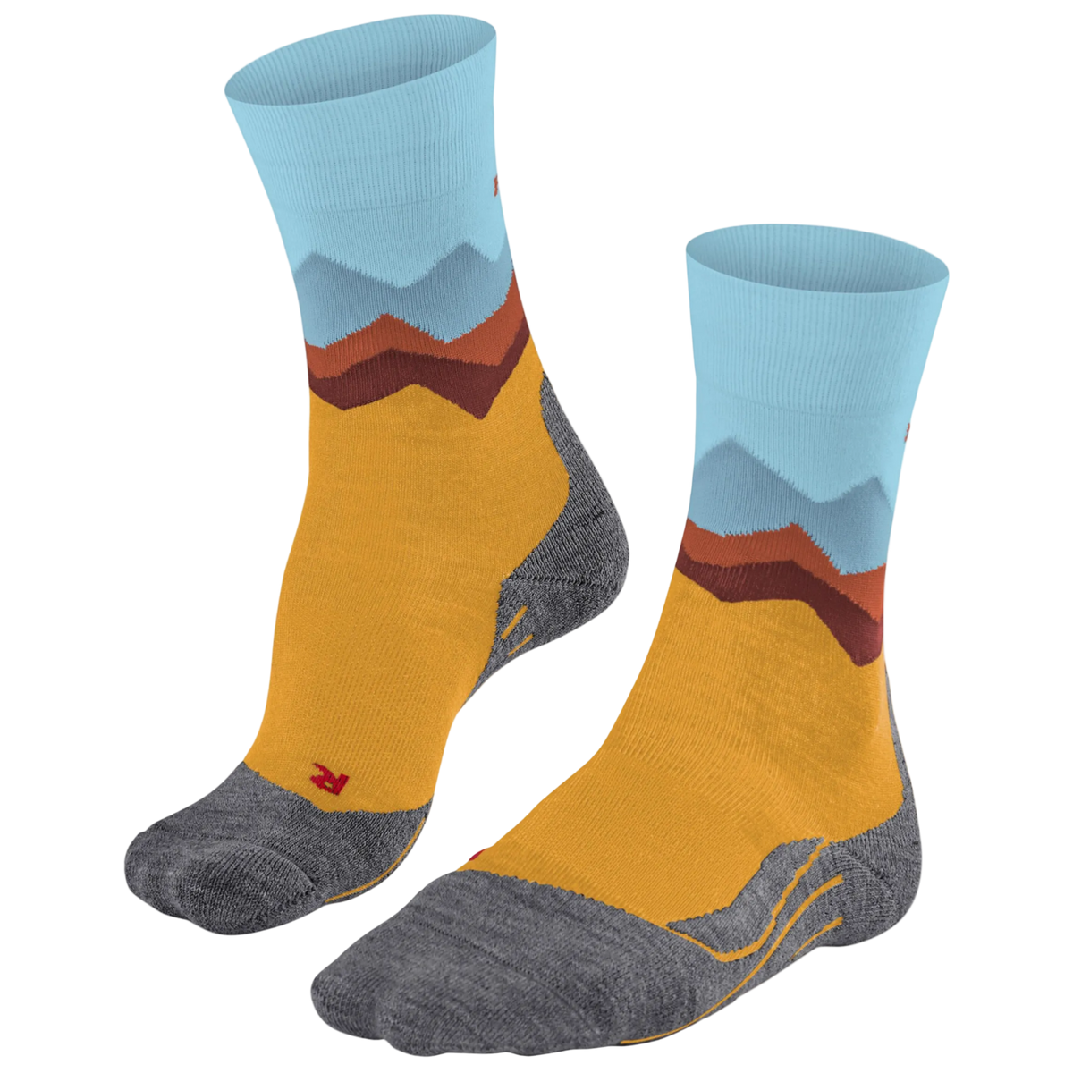 A pair of crew socks with a mountain landscape pattern, featuring a mustard yellow body, gray toe and heel areas, and light blue and brown mountain peaks on the cuff.