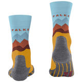 A pair of crew socks shown from the front and back on a plain white background. The socks feature a light blue upper cuff with the brand name 'FALKE' in red, a stylized mountain graphic in blue, brown, and orange, a mustard yellow lower section, and a gray heel, toe, and sole.