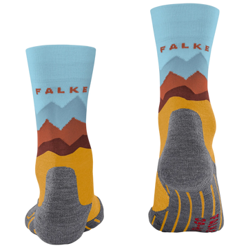 A pair of crew socks shown from the front and back on a plain white background. The socks feature a light blue upper cuff with the brand name 'FALKE' in red, a stylized mountain graphic in blue, brown, and orange, a mustard yellow lower section, and a gray heel, toe, and sole.