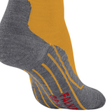 A close-up of a single sock on a white background, featuring a heather gray knit heel, toe, and sole with yellow stripes, a mustard yellow main body, and a dark brown section near the top.