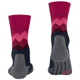 A pair of FALKS crew socks shown from both the front and back views on a plain white background. The socks feature a magenta and pink mountain pattern on the upper leg, a dark navy blue lower section, and a heather gray toe and heel area.