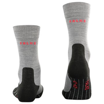 A pair of gray heathered crew socks with black reinforced heels, toes, and soles, featuring the brand name 'FALKE' printed in red on the side and sole.